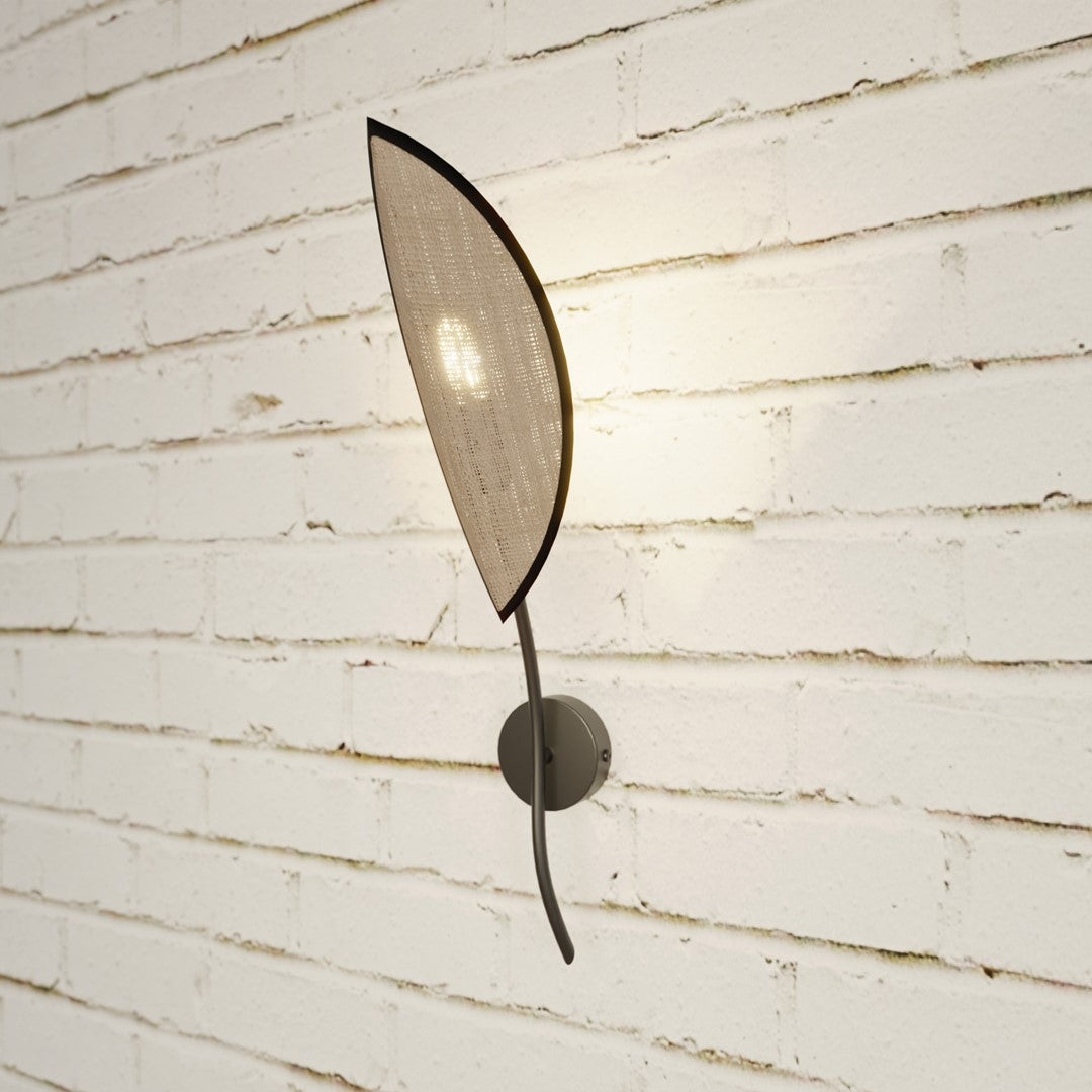 Applique fixée sur mur de briques blanches, halo lumineux diffusé tout autour