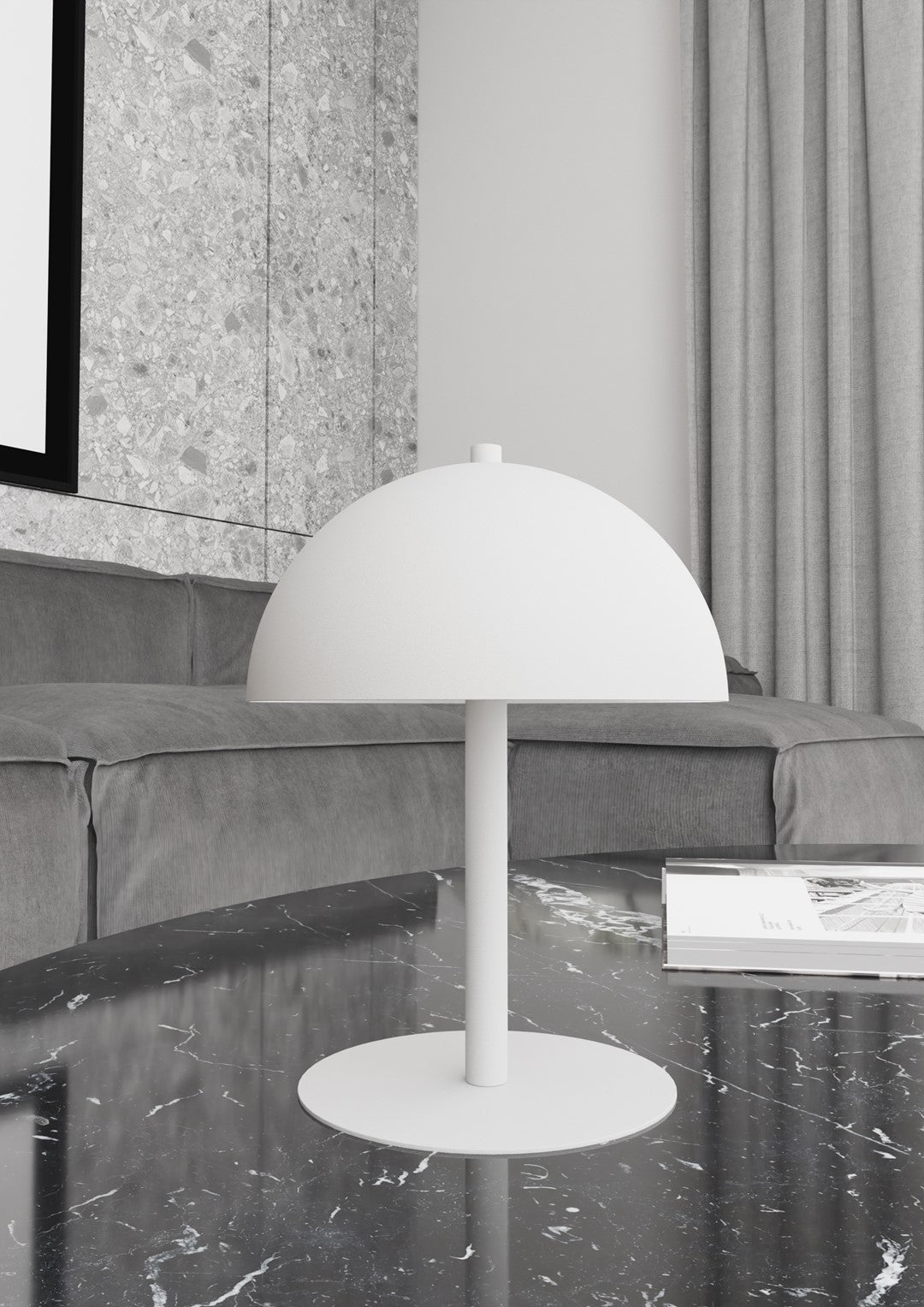 Lampe de table blanche posée sur table en marbre noir devant un canapé gris