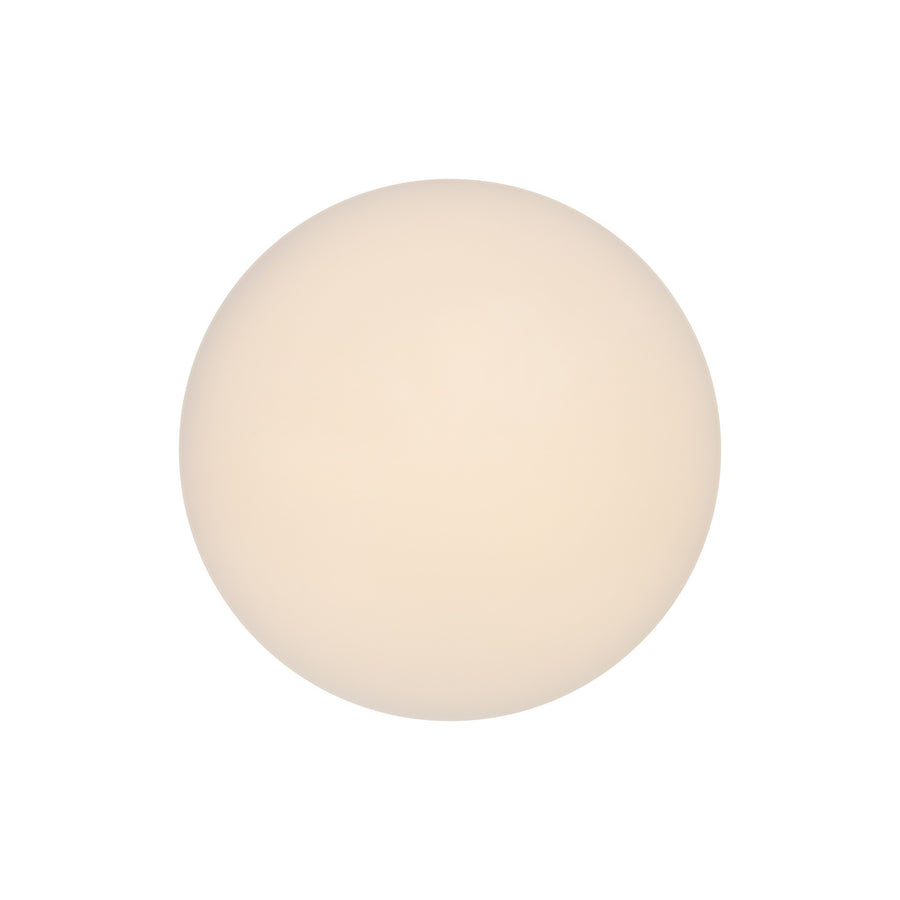 Vue frontale du luminaire allumé, disque circulaire diffusant une lumière chaude uniforme