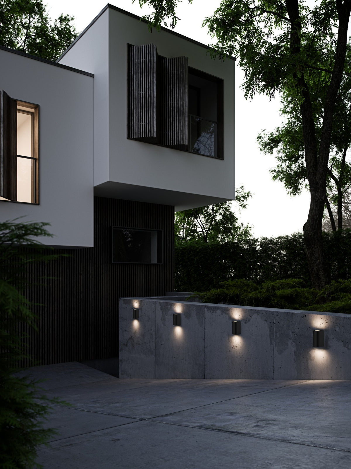 Mise en ambiance : quatre appliques noires éclairant un mur béton moderne