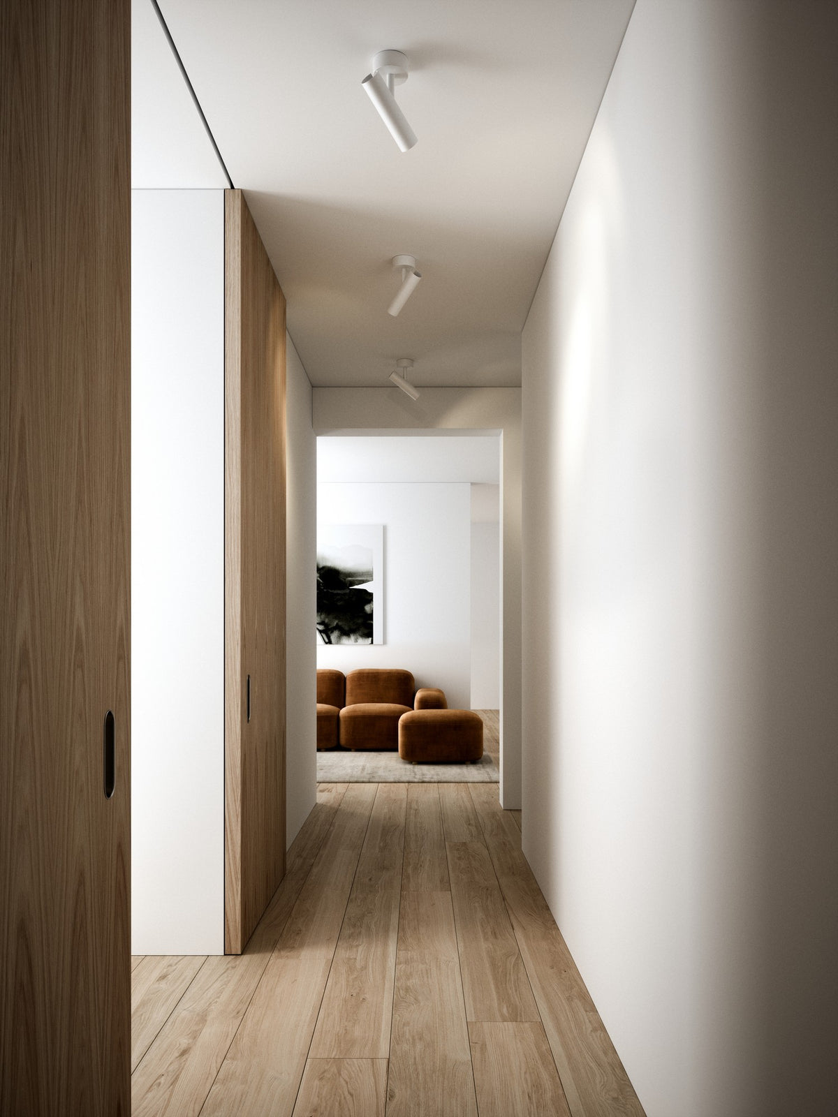 Mise en ambiance d'un couloir clair avec trois spots blancs fixés au plafond.