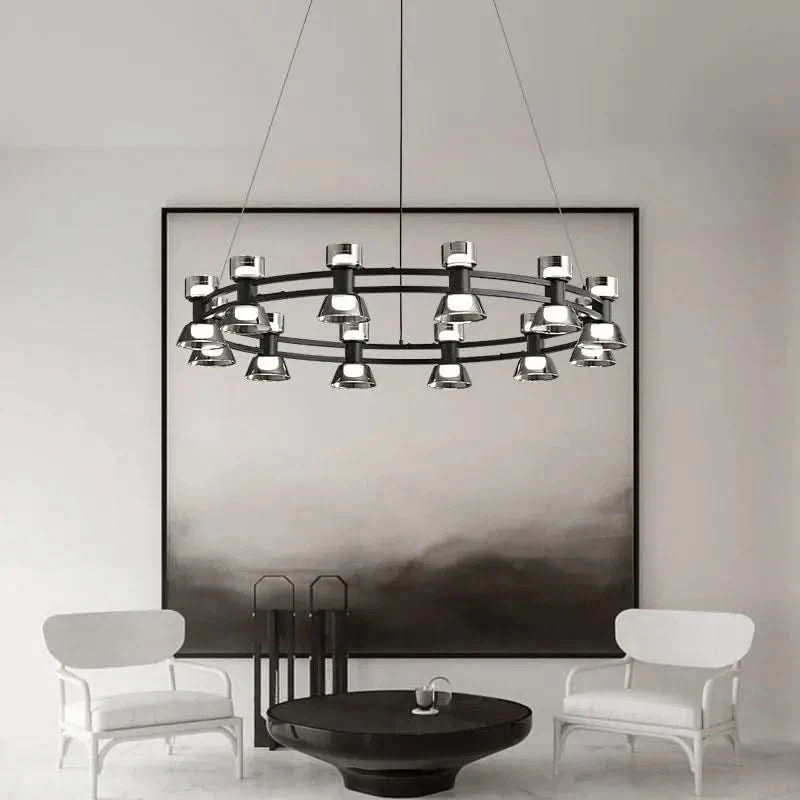 Grand lustre anneau noir et verre au-dessus d'une table basse ronde