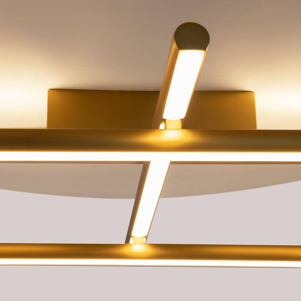 Détail rapproché d'un tube lumineux incliné, finition dorée satinée