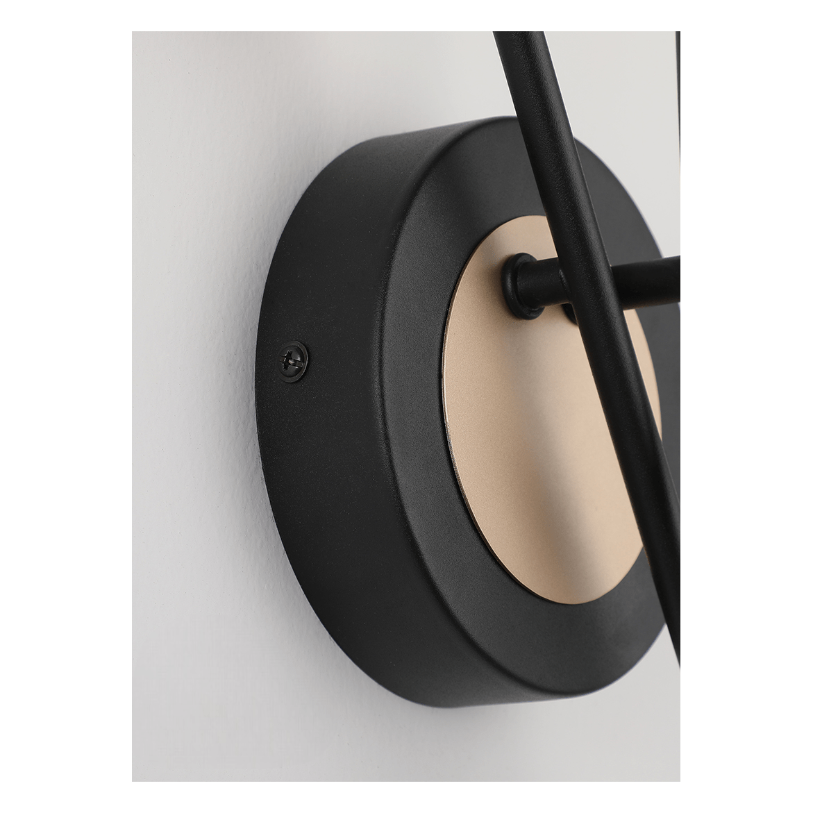 Détail de la base ronde noire et du disque doré central avec vis de fixation