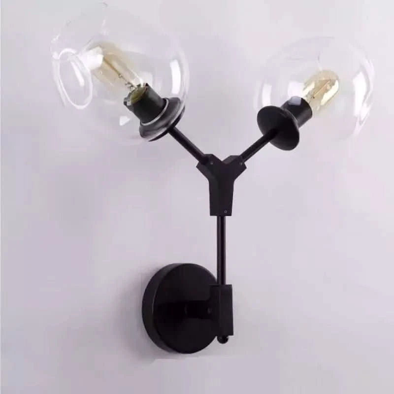 Version noire mate à deux globes transparents éteints, fixée sur un mur clair