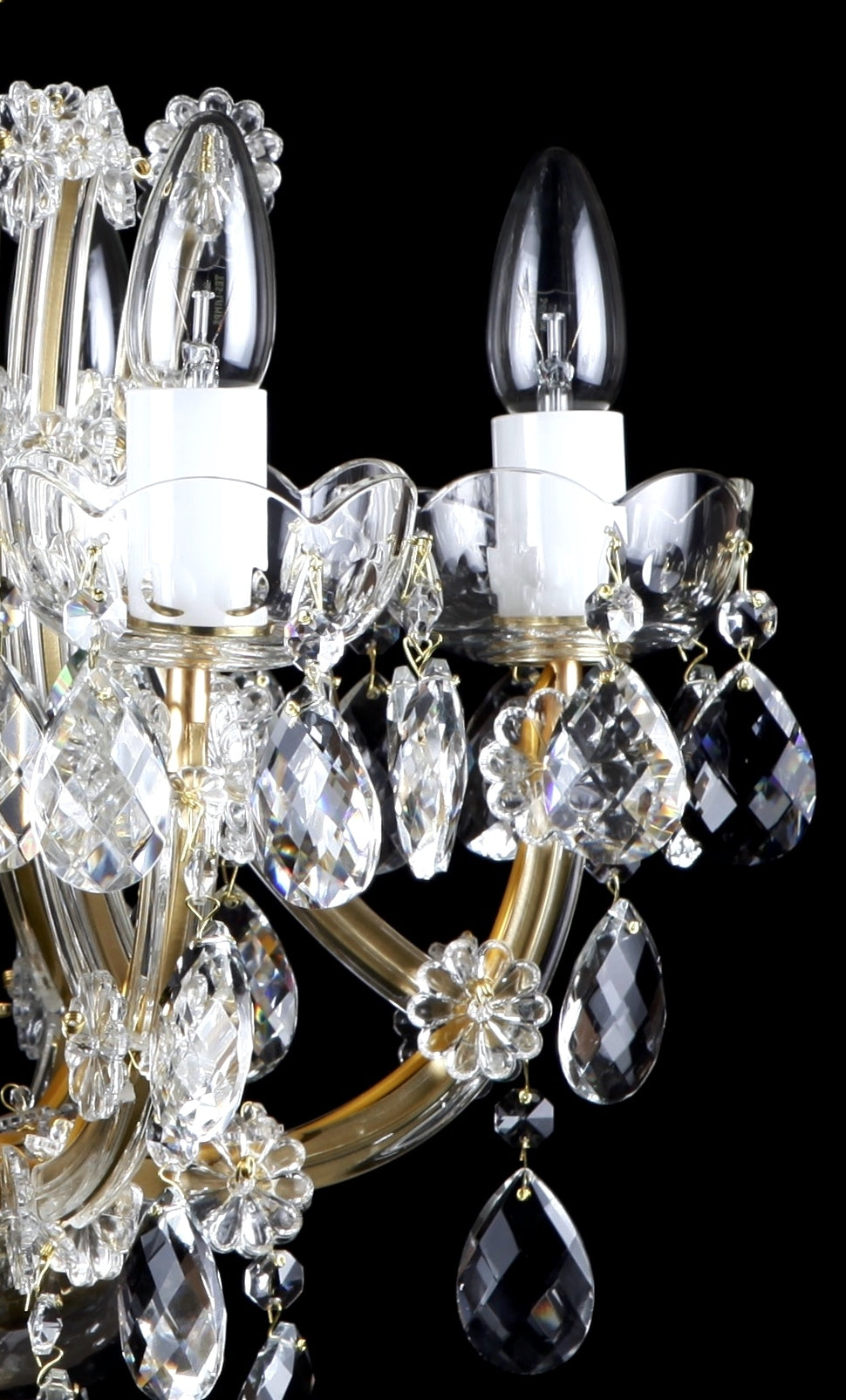 Gros plan sur les bobèches en verre festonné et les gouttes de cristal facettées.