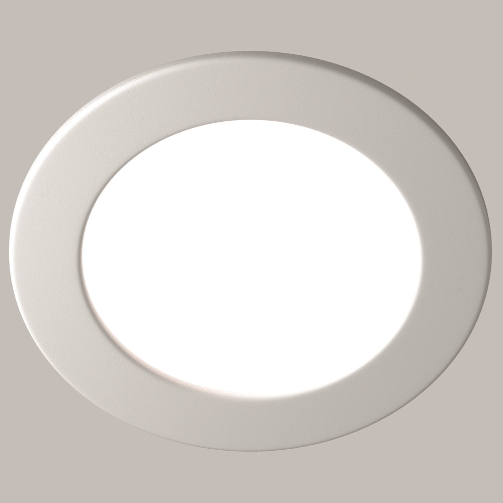 Spot rond blanc présenté de face sur un fond beige clair neutre