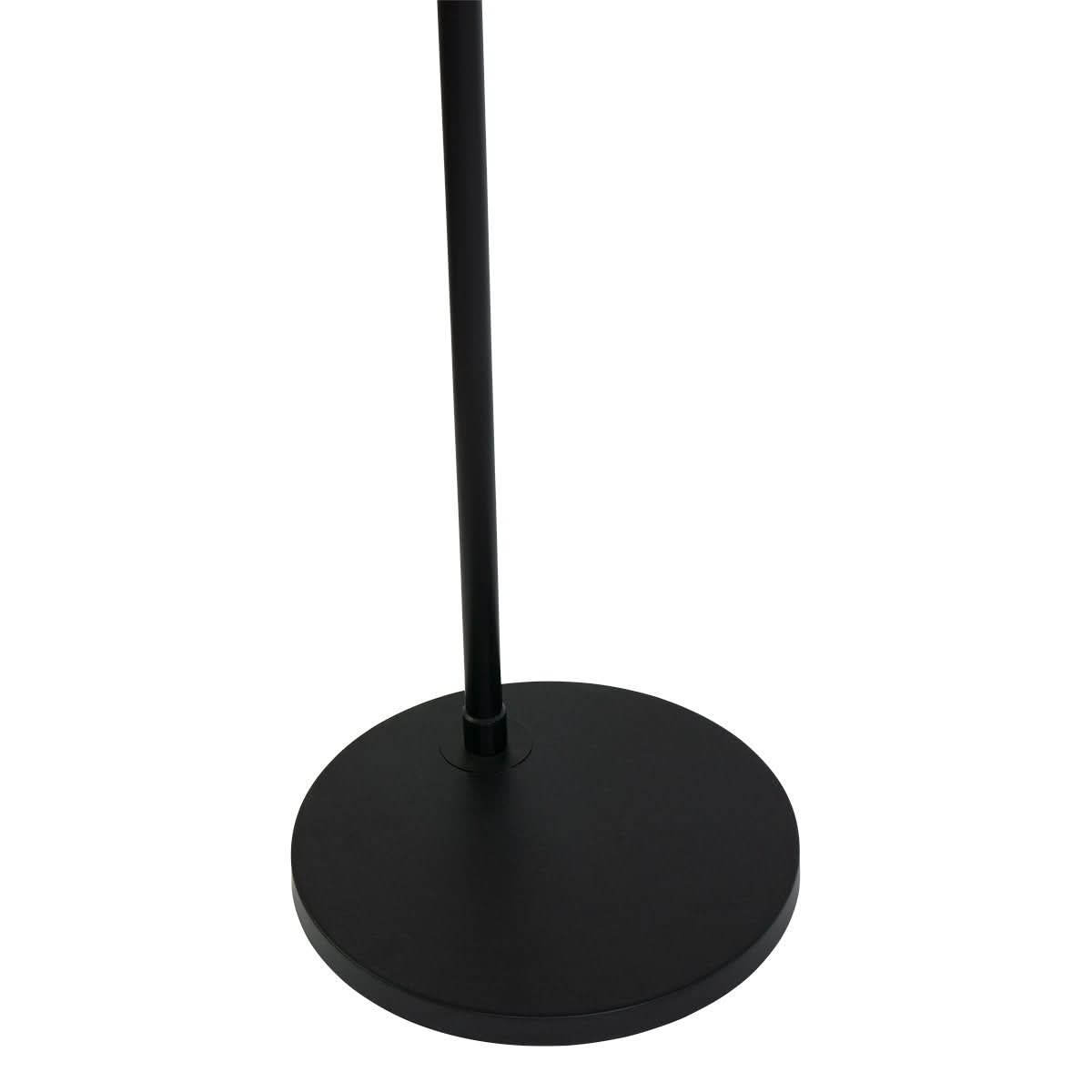 Détail de la base ronde noire et du pied métallique du lampadaire posé au sol.