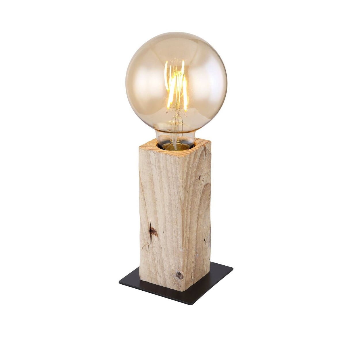 Lampe à poser en bois brut sur socle noir, ampoule globe ambrée allumée, fond blanc