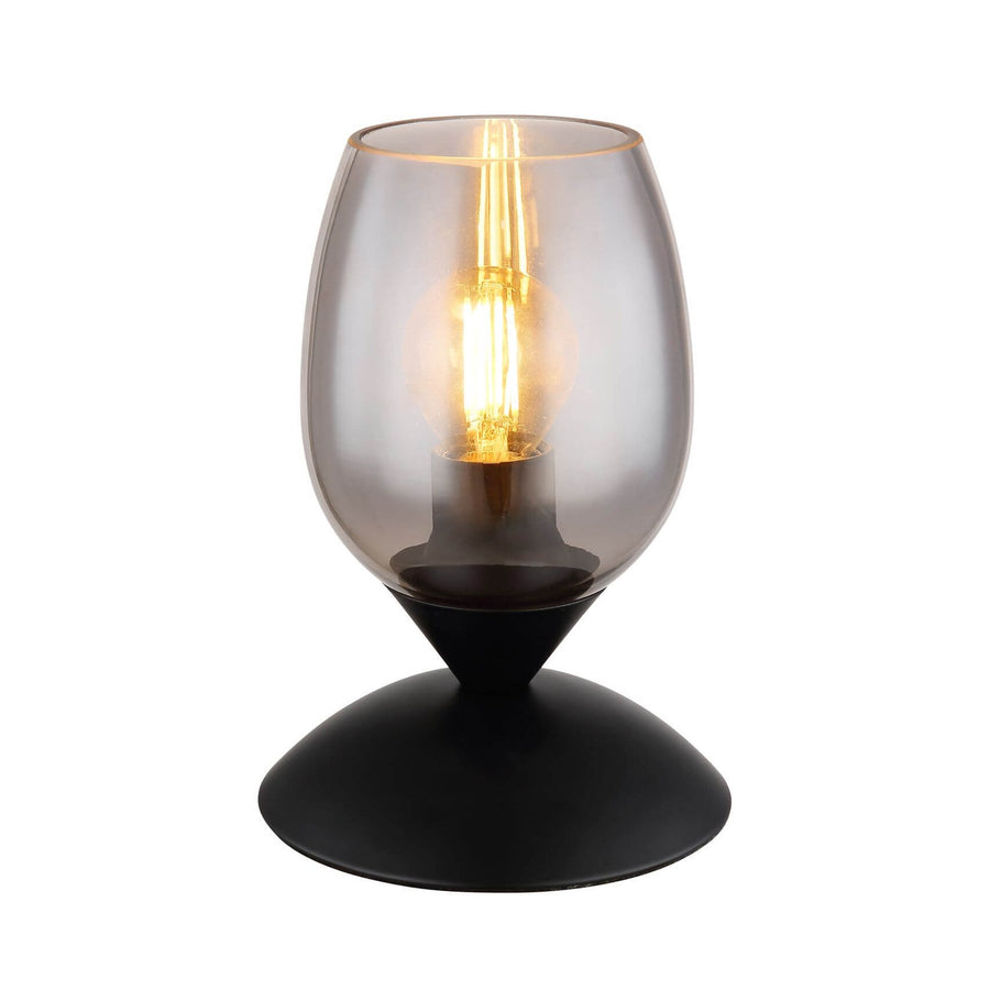 Lampe à poser de face sur fond blanc, verre fumé et socle noir mat