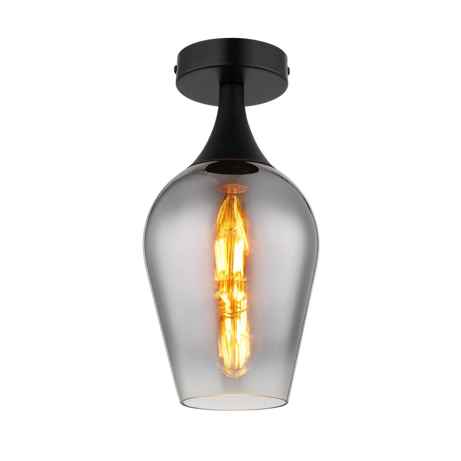 Plafonnier noir mat avec abat-jour en verre fumé et ampoule filament allumée, vue de face.