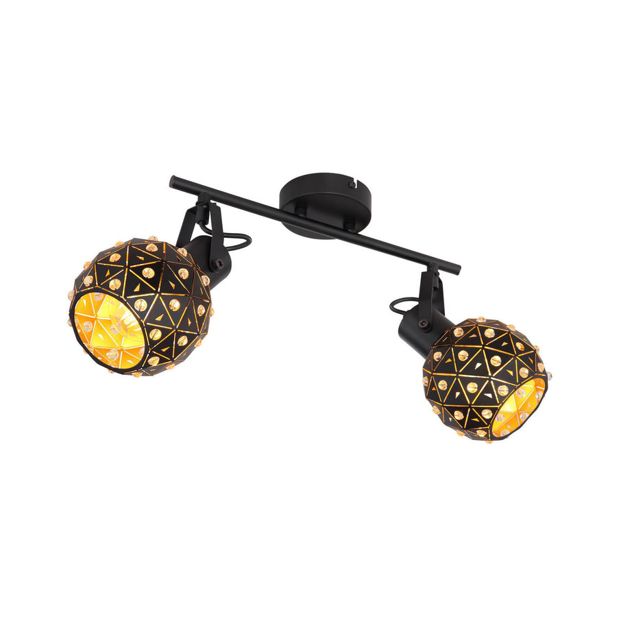 Vue de trois quarts du luminaire noir à deux spots, têtes sphériques et finitions dorées.