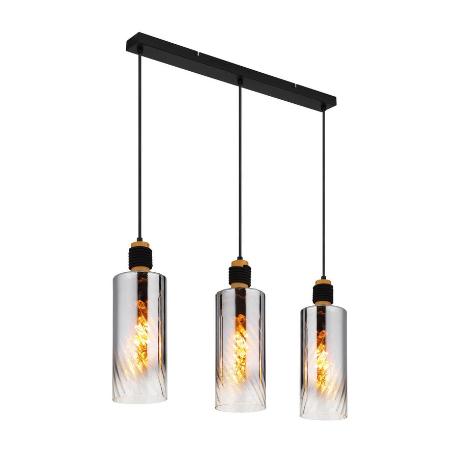 Vue de face du luminaire à trois suspensions, verres cylindriques et ampoules allumées