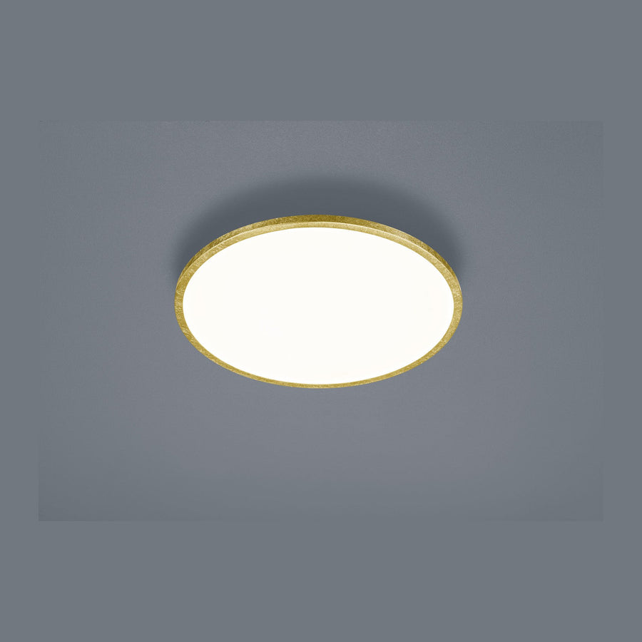 Plafonnier rond doré monté au plafond, finition métallique et diffuseur blanc.