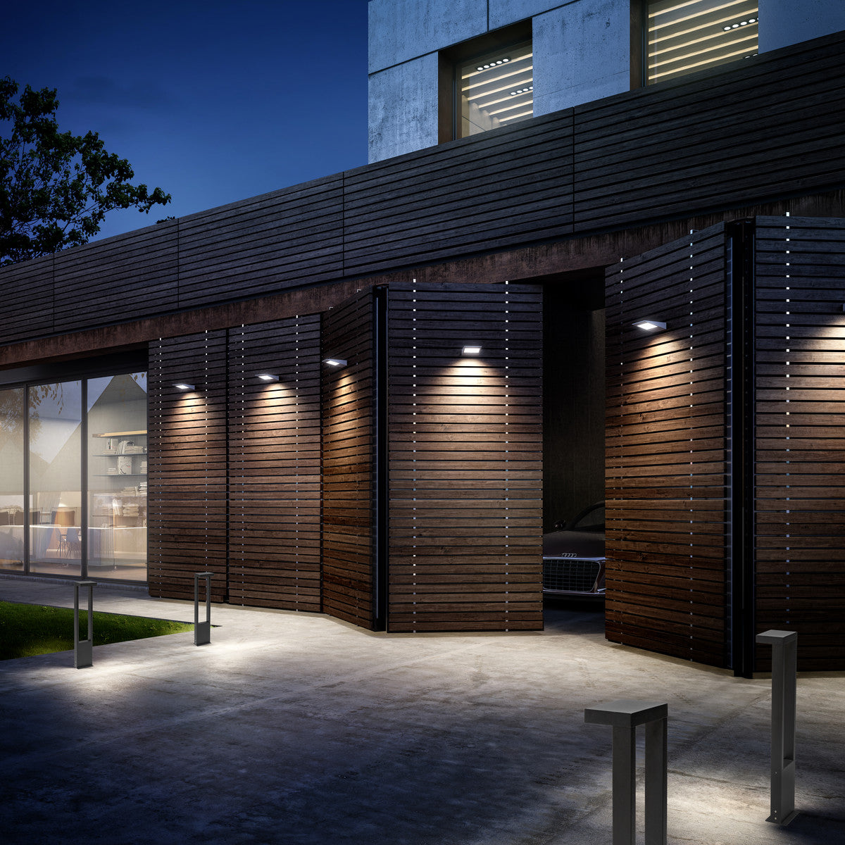 Mise en ambiance nocturne : bornes anthracite éclairant une façade en lattes de bois