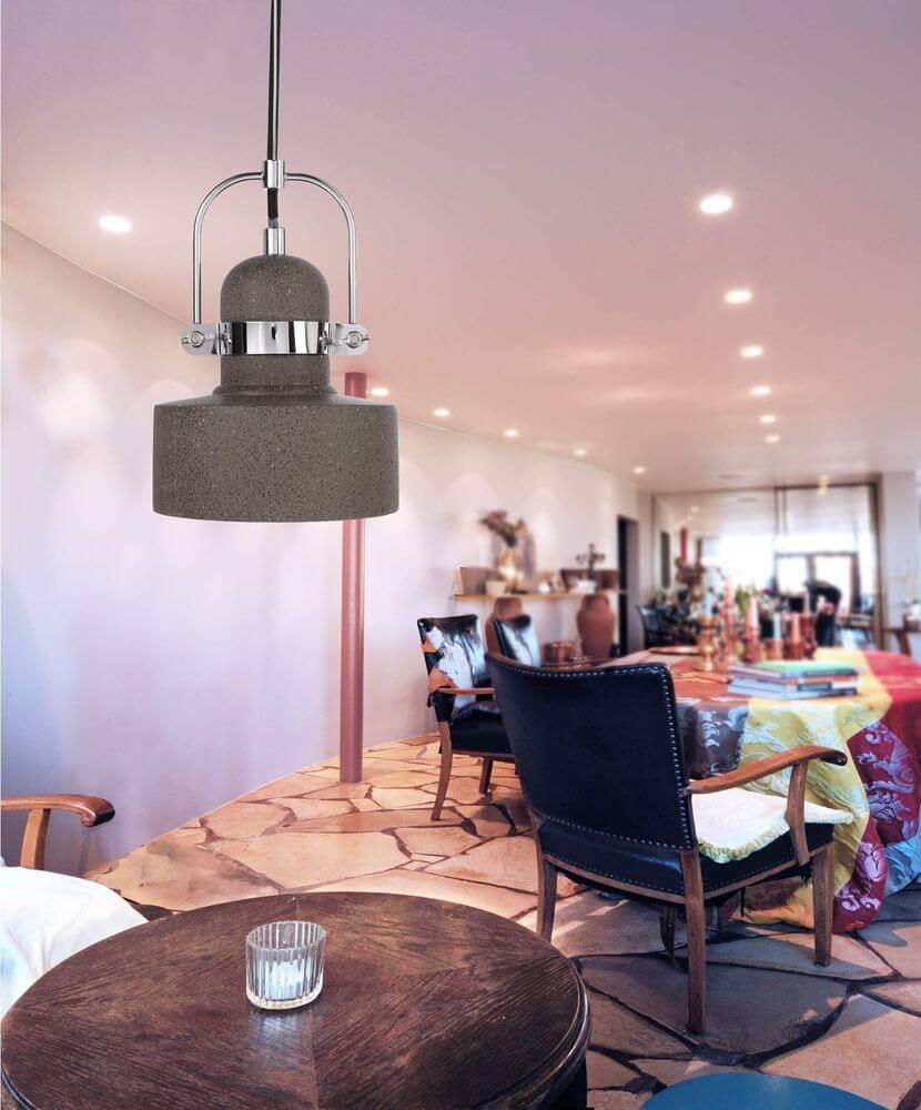 Suspension en béton suspendue au-dessus d'une table dans une salle à manger chaleureuse.