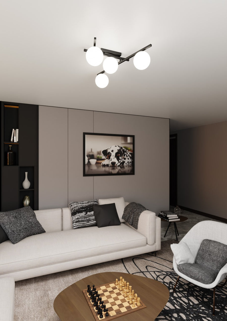 Luminaire allumé au-dessus d’un salon gris, canapé blanc et cadre photo