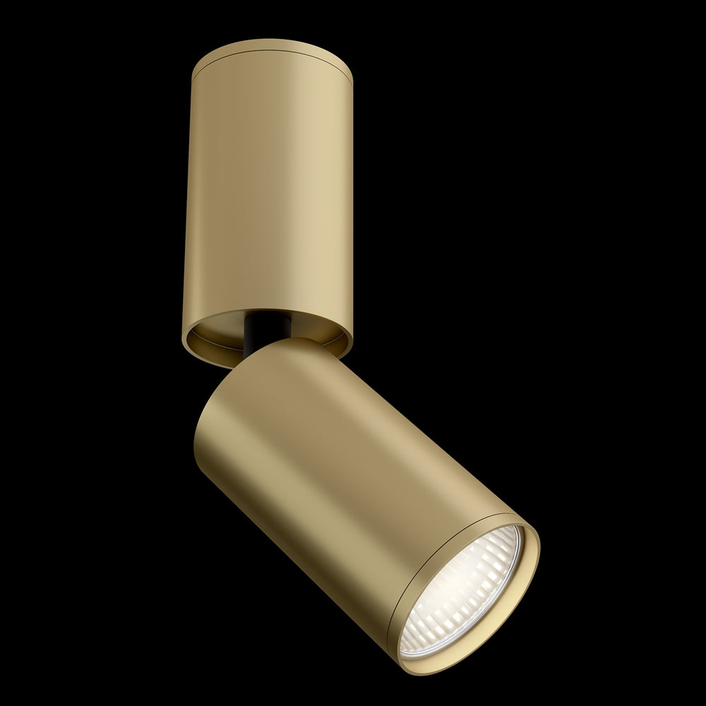 Spot dore incline, corps cylindrique et diffuseur strie, presente sur fond noir