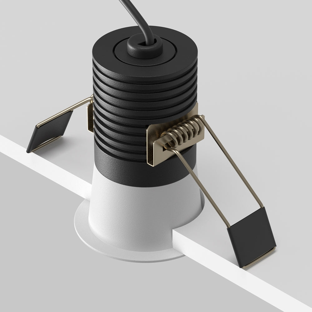 Vue de profil montrant le corps cylindrique noir, ressorts et câble d'alimentation