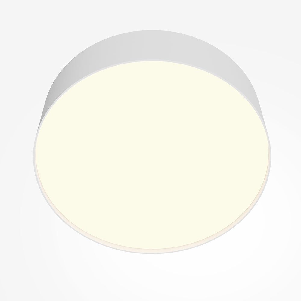 Gros plan sur le diffuseur rond allumé, lumière chaude et uniforme
