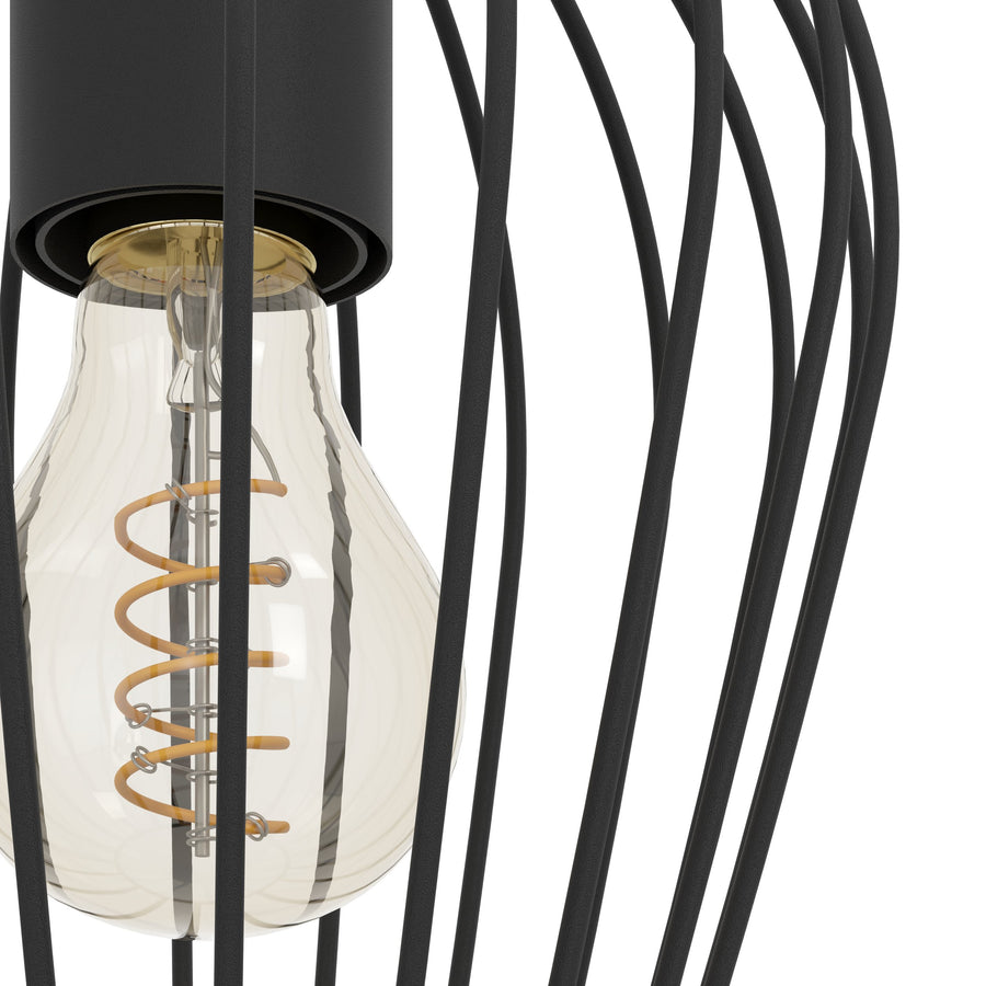 Gros plan sur l'ampoule dorée et la douille dans la cage noire