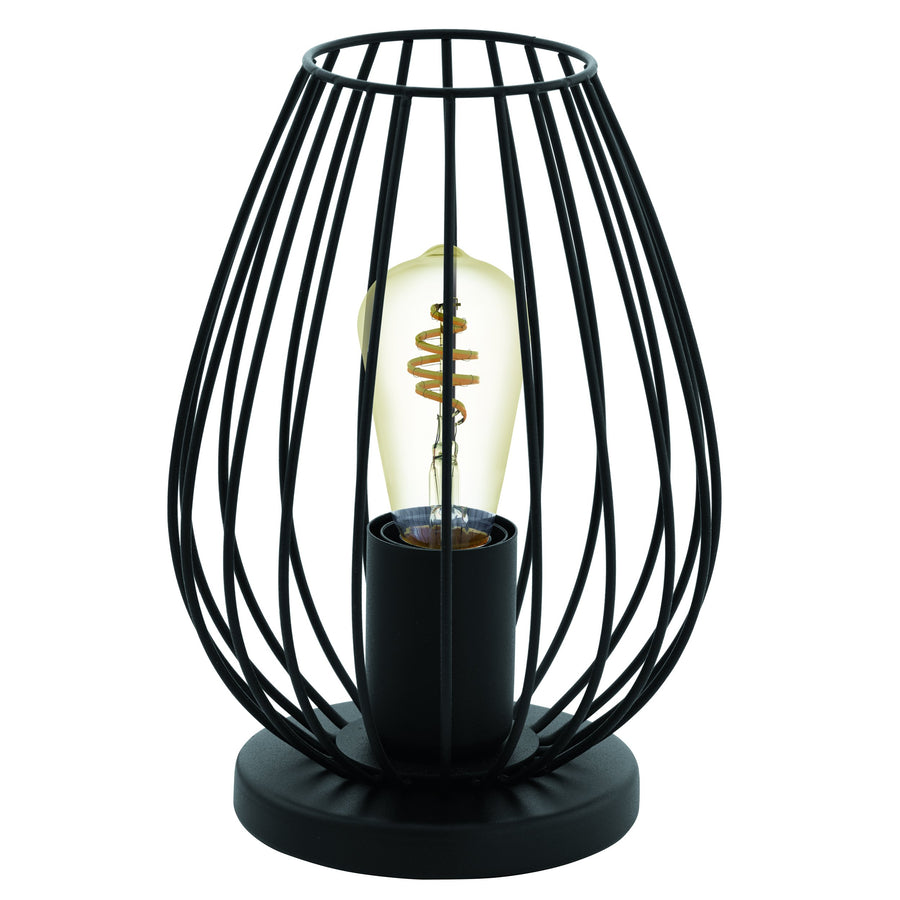Lampe à poser noire en cage métallique, ampoule spirale allumée sur fond blanc