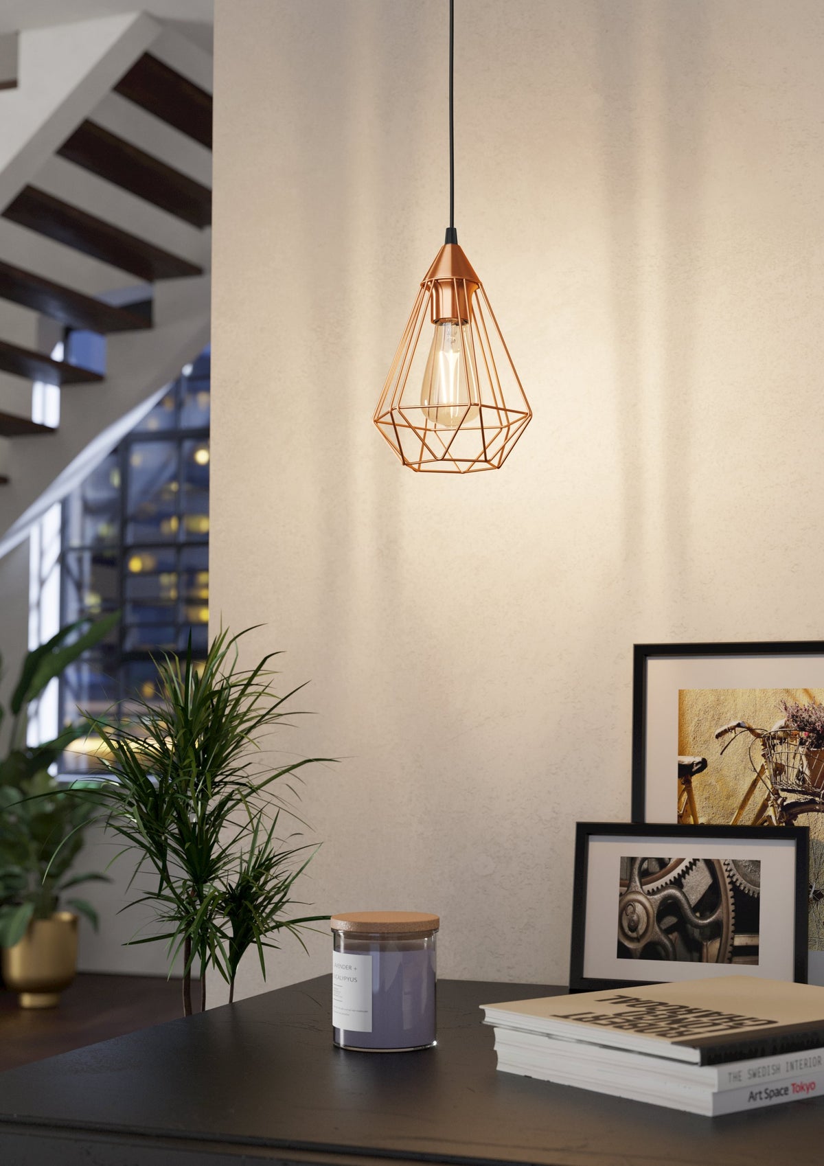Mise en ambiance dans un intérieur, suspension allumée au-dessus d'une table et d'une plante