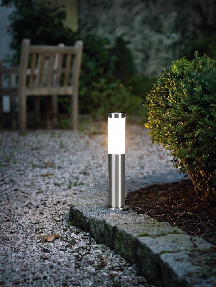 Mise en ambiance nocturne dans un jardin de graviers, près d'un buisson et d'un banc