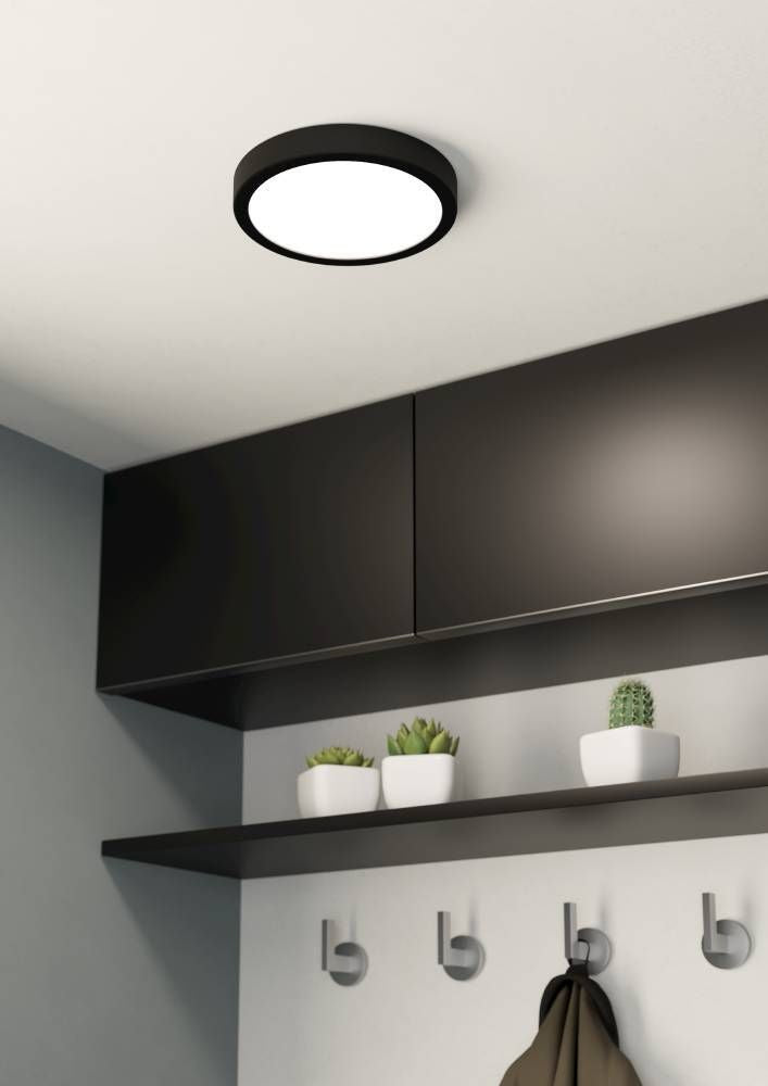 Luminaire rond installé au plafond d'une entrée moderne et sombre