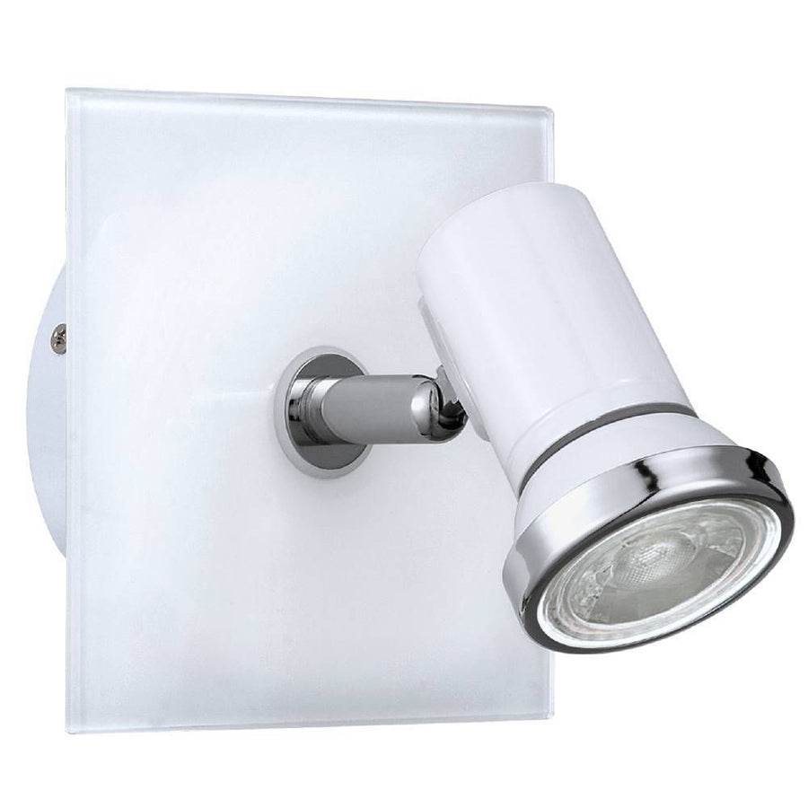 Spot mural vu de face sur fond blanc, platine carrée en verre et projecteur cylindrique