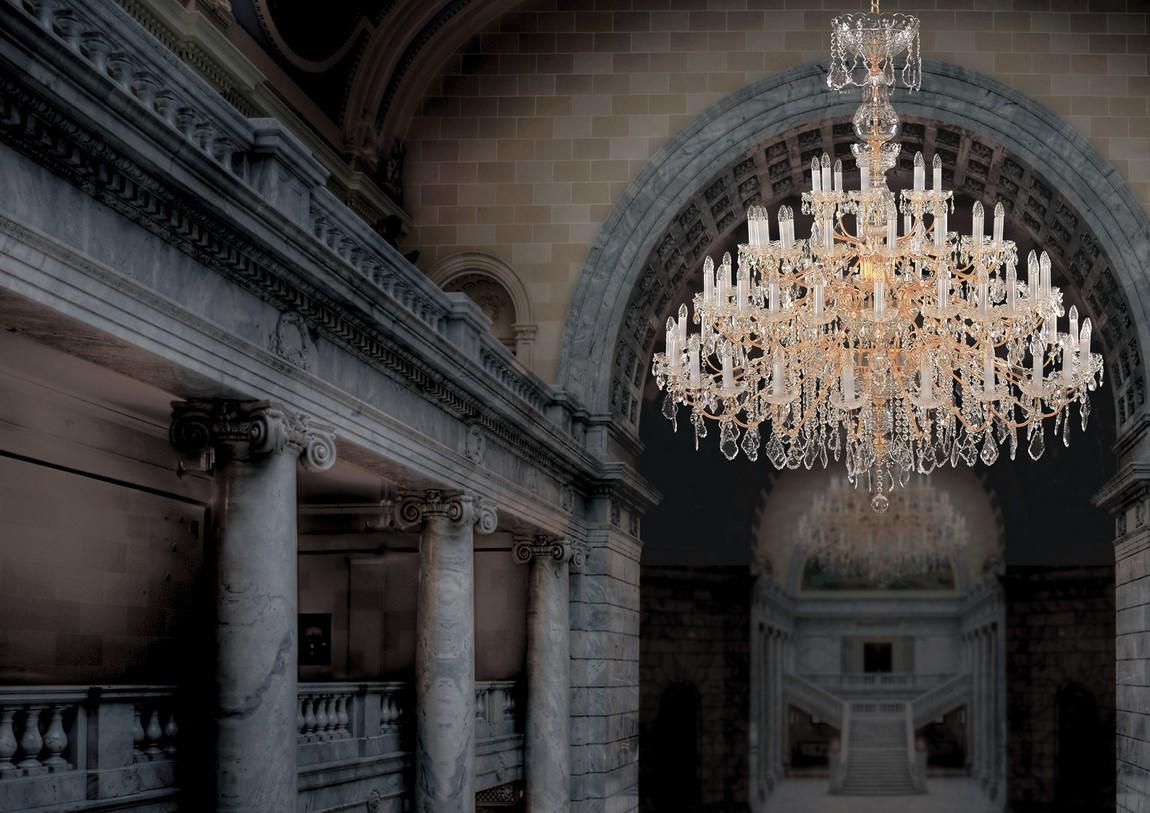 Mise en ambiance du lustre suspendu sous une arche de pierre dans un hall monumental