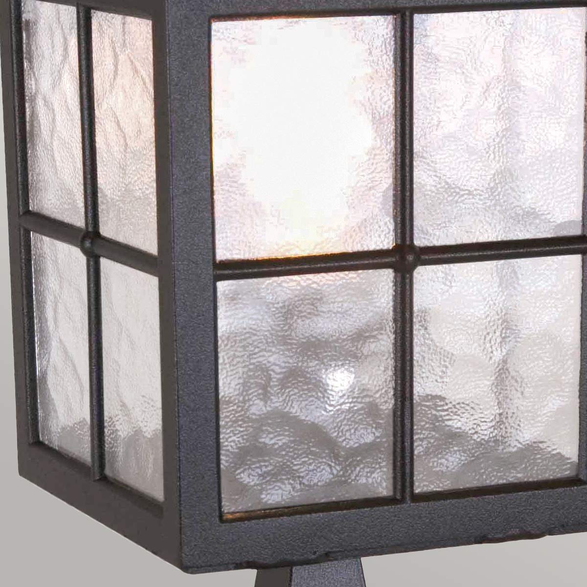 Zoom sur le verre texturé et la grille de maintien en métal noir.