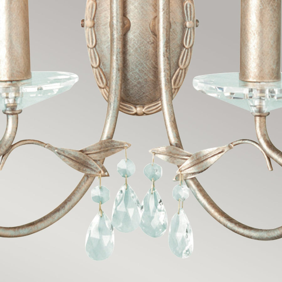 Détail du métal patiné, des feuilles décoratives et des pendentifs en cristal