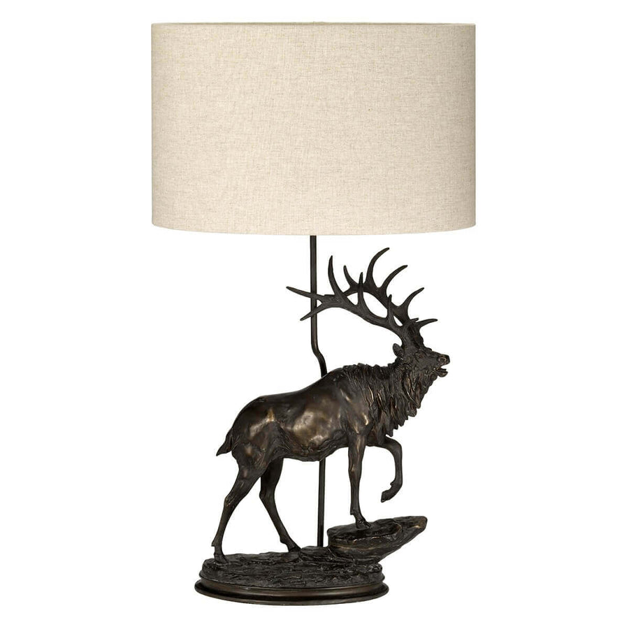 Vue de face du luminaire, socle sculpté et abat-jour cylindrique beige
