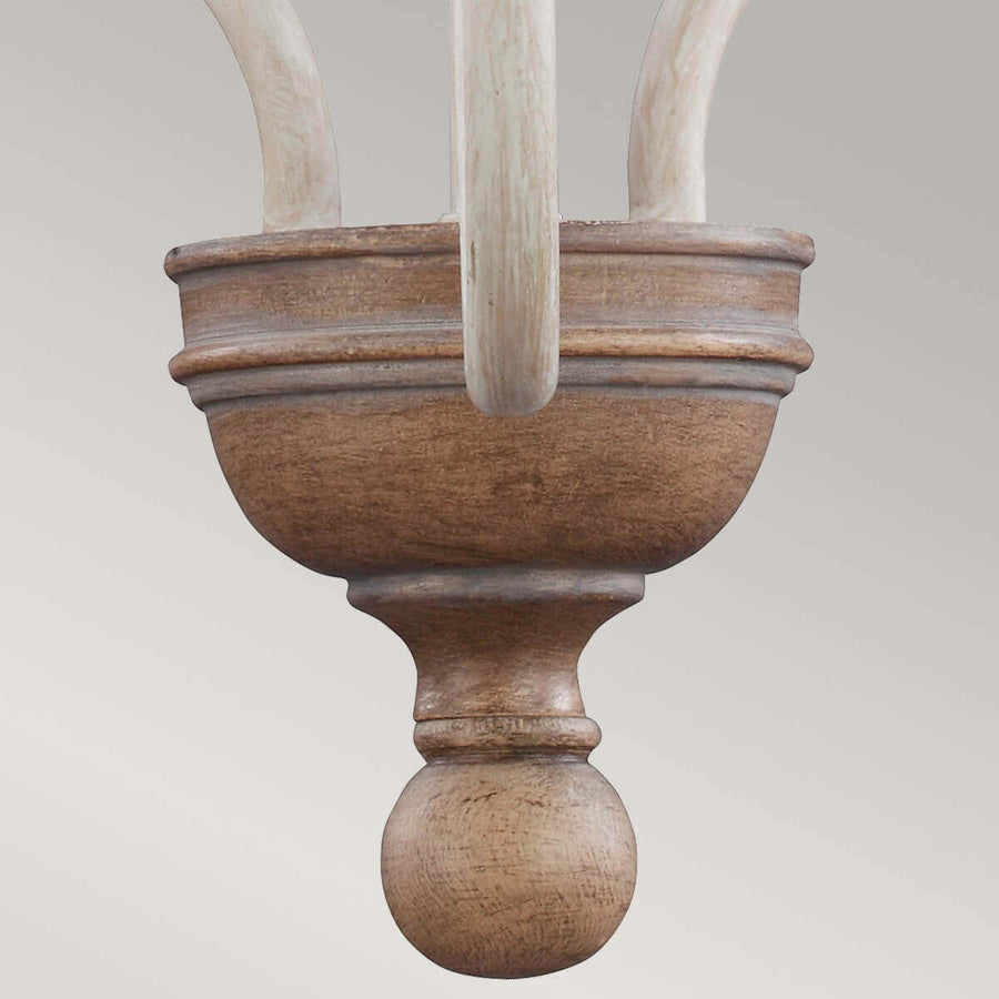 Détail de l'élément central inférieur, bois vieilli et boule en bois sculpté.