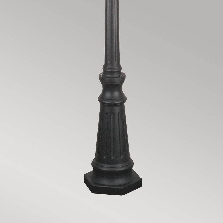 Détail de la base trapézoïdale cannelée posée sur un socle octogonal noir