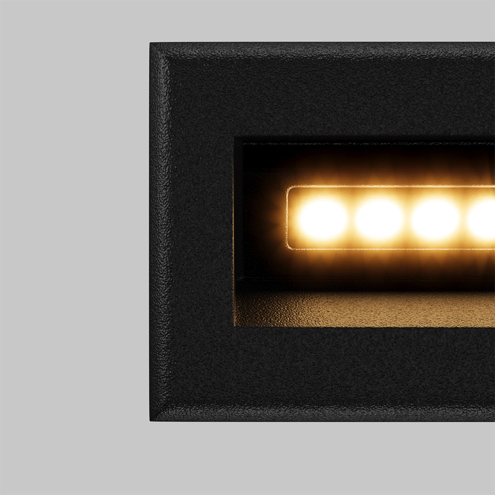 Détail rapproché du cadre noir granuleux et des LED chaudes alignées