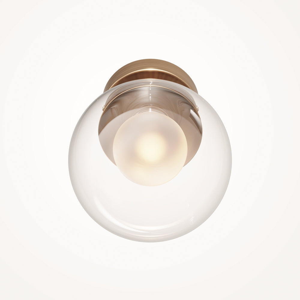 Vue rapprochée de face, sphère lumineuse blanche entourée d'un globe transparent.
