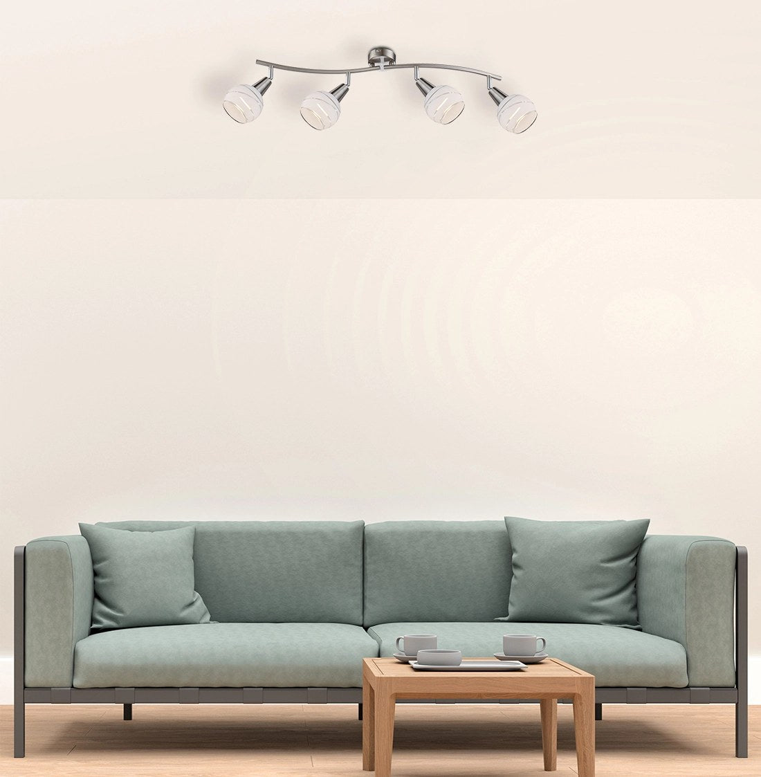 Plafonnier fixé au plafond dans un séjour, au-dessus d'un canapé vert et table basse.