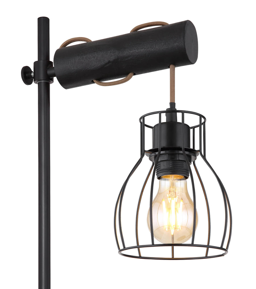 Gros plan sur l'abat-jour cage et l'ampoule Edison allumée