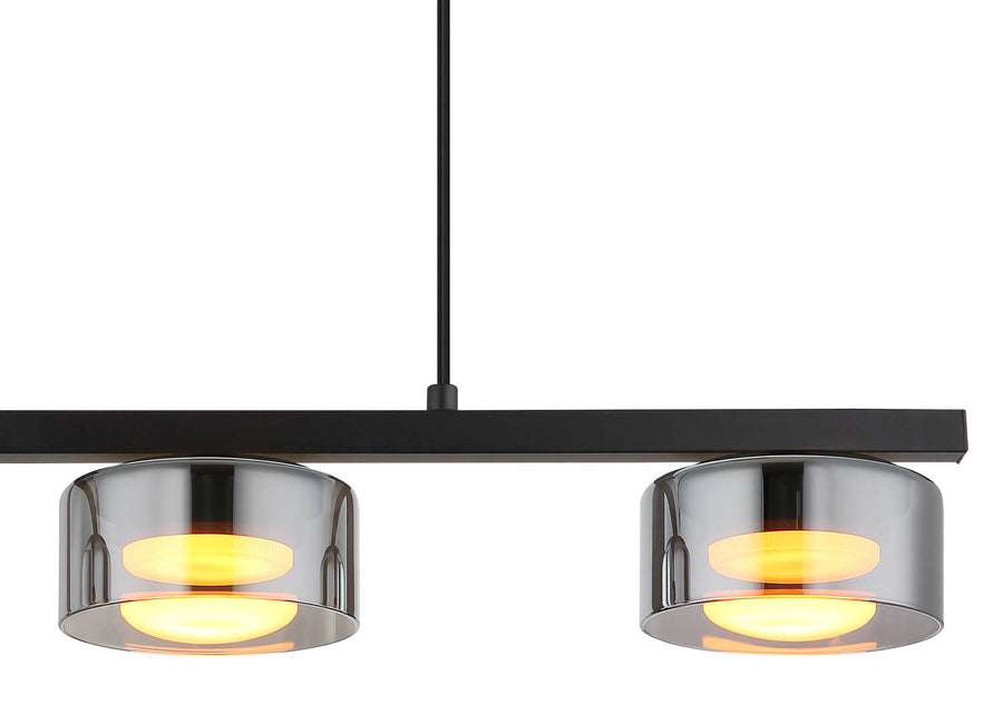 Gros plan sur deux diffuseurs cylindriques chromés diffusant une lumière jaune chaude