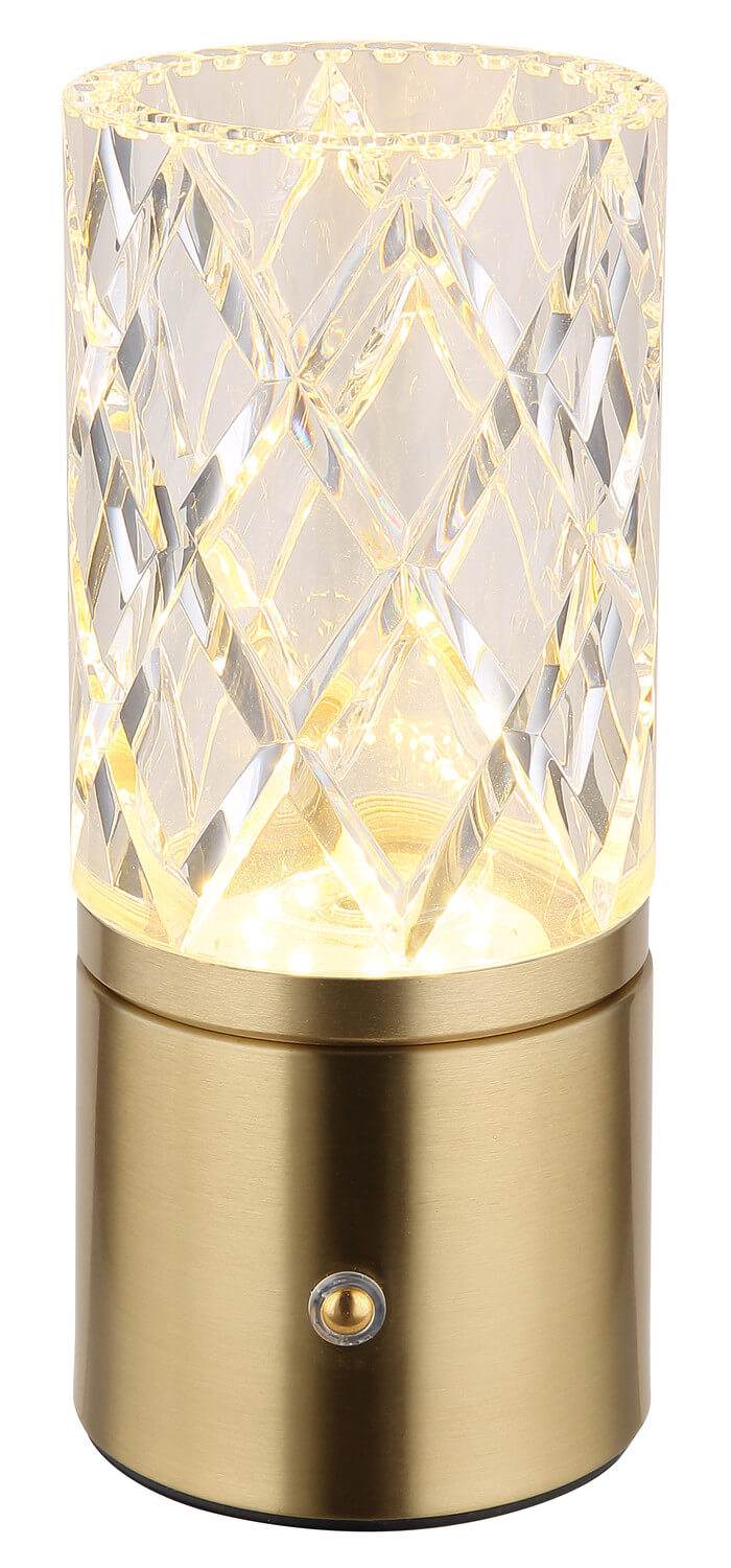 Photographie du luminaire allumé diffusant une lumière chaude à travers le cristal.