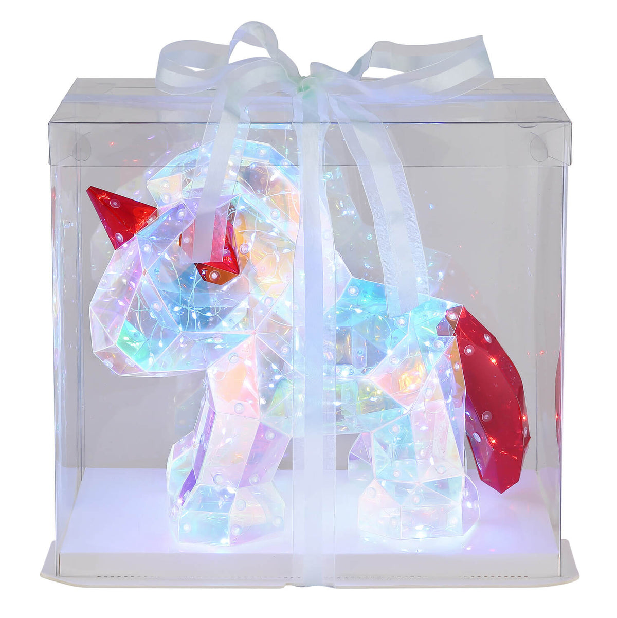 Luminaire allumé de face dans sa boîte transparente fermée par un ruban.