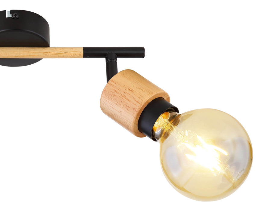 Détail de la finition : douille bois, col noir et ampoule dorée lumineuse