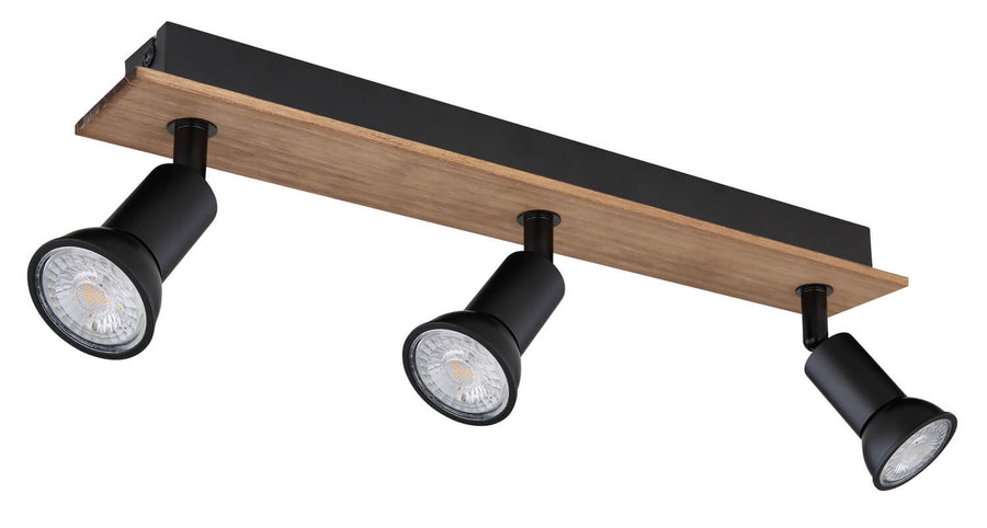 Vue rapprochée du luminaire montrant trois projecteurs noirs, leurs ampoules et la platine en bois.