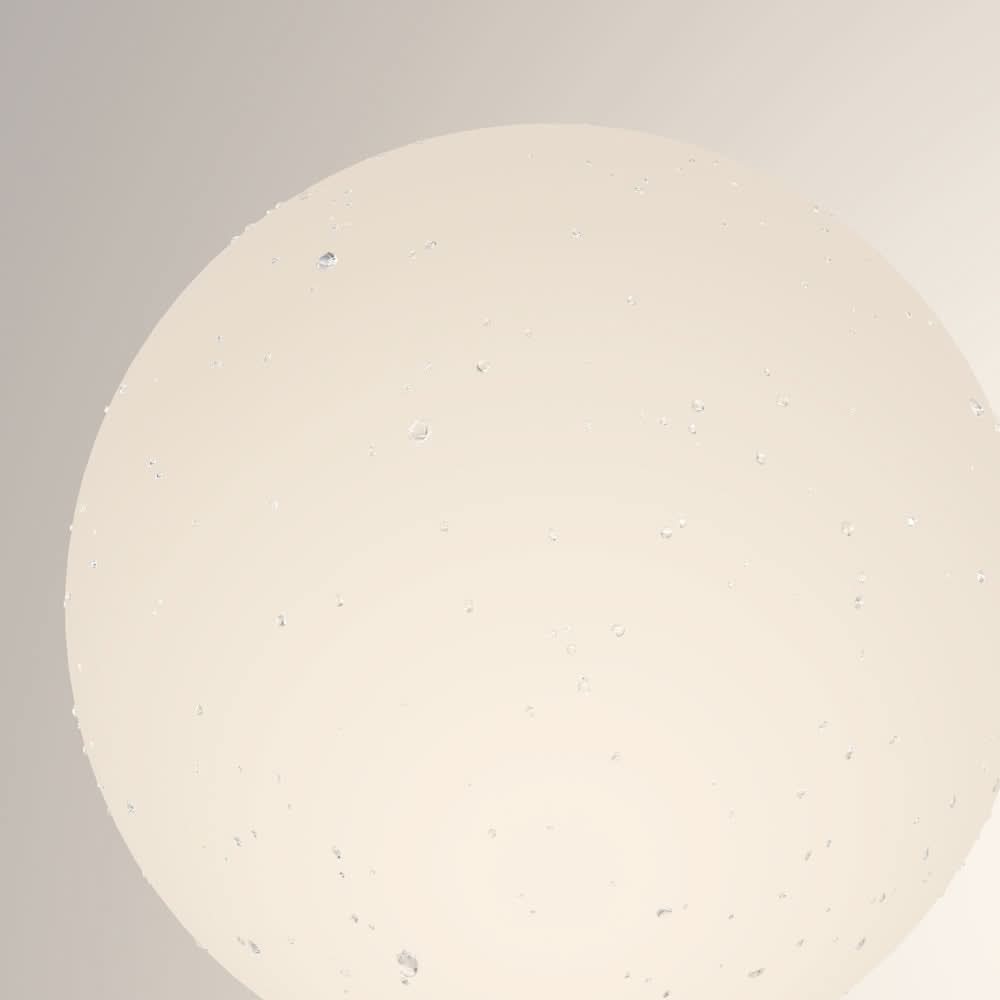 Détail de la matière du globe en verre moucheté de petites bulles claires
