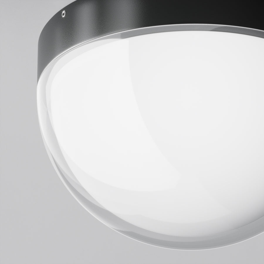 Détail rapproché de la collerette métallique et du verre opalin avec vis apparente