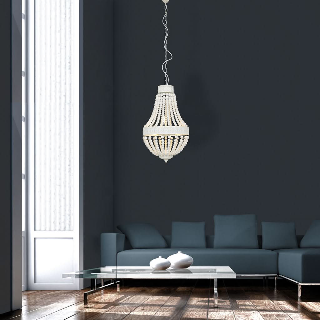Luminaire suspendu devant un mur anthracite au-dessus d'un canapé bleu