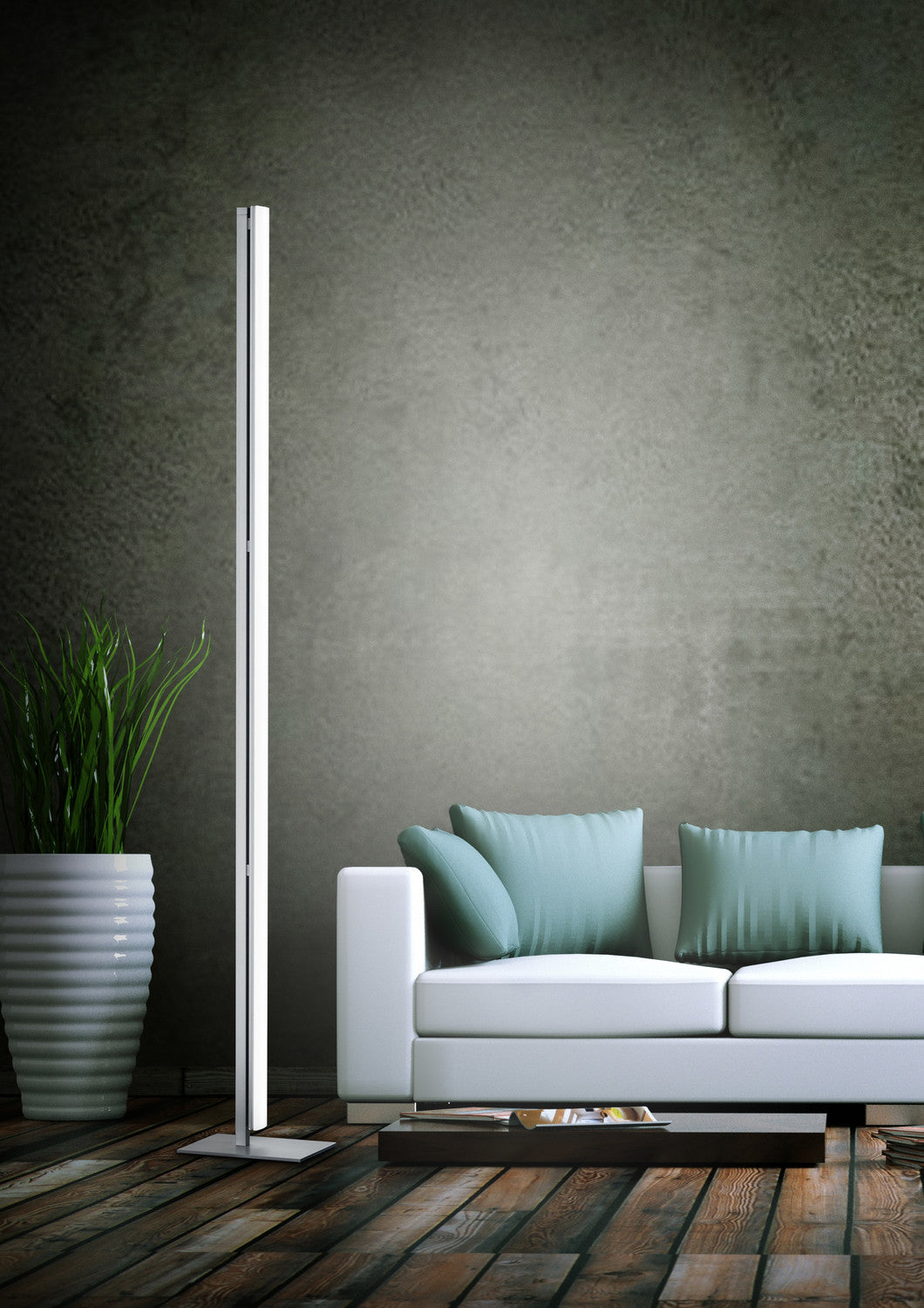 Mise en ambiance : lampadaire vertical éclairant un mur derrière un canapé blanc.