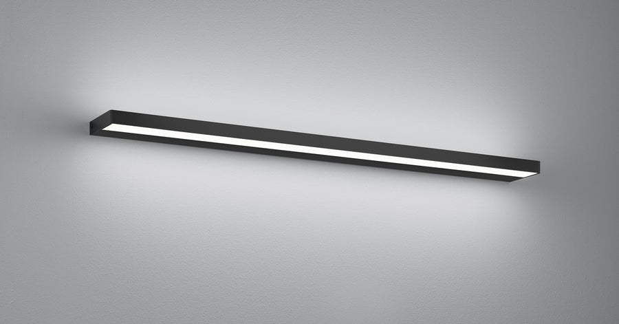 Vue en perspective de l'applique noire fixée au mur, lumière blanche diffuse.